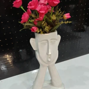 Modern face flower vase with pink floral arrangement for luxury home décor and stylish interiors.