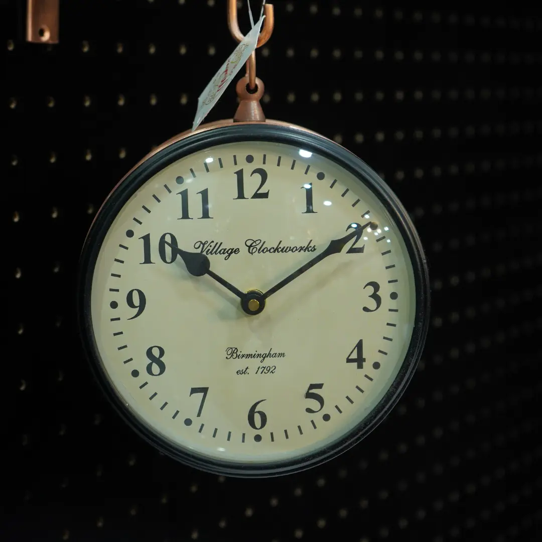Vintage hanging wall clock with antique metal finish for living room décor.
